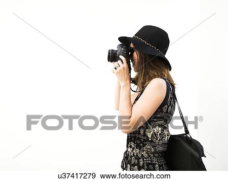 Stock Photo - Woman taking photos during vacations. Fotosearch