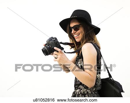 Stock Photograph - Woman taking photos during vacations. Fotosearch