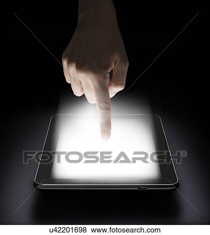 Woman touching digital tablet in studio View Large Photo Image Stock Photo - Woman touching digital tablet in studio. Fotosearch