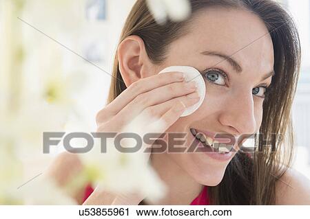 Stock Image - Woman using cotton pad. Fotosearch