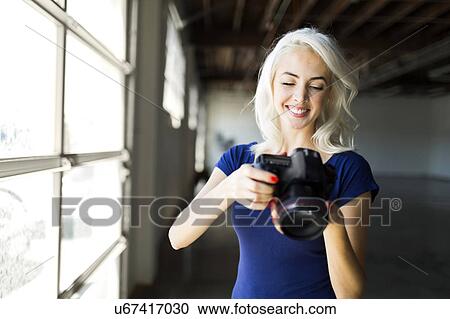 Woman using digital camera View Large Photo Image Stock Image - Woman using digital camera. Fotosearch