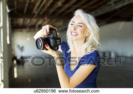Woman using digital camera View Large Photo Image Stock Photograph - Woman using digital camera. Fotosearch