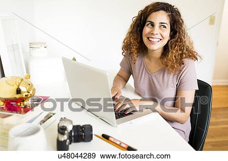Stock Photo - Woman using laptop. Fotosearch