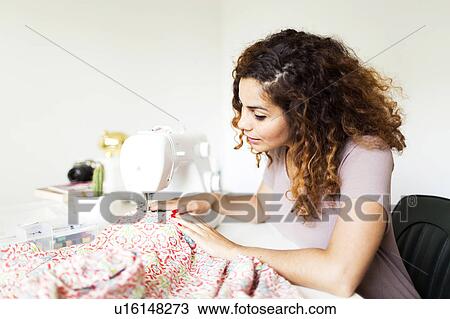 Woman using sewing machine View Large Photo Image Stock Image - Woman using sewing machine. Fotosearch