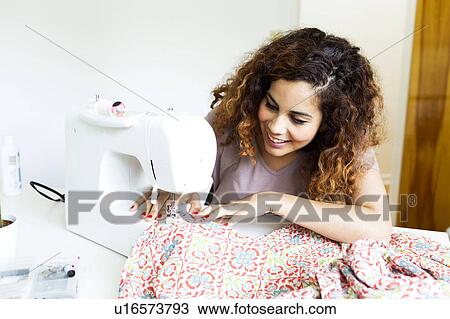 Woman using sewing machine View Large Photo Image Stock Image - Woman using sewing machine. Fotosearch