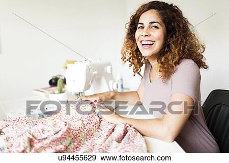 Woman using sewing machine View Large Photo Image Stock Photo - Woman using sewing machine. Fotosearch