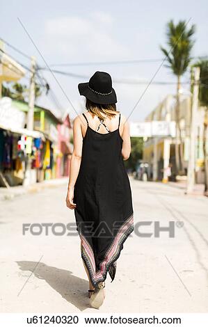 Woman walking in street View Large Photo Image Stock Image - Woman walking in street. Fotosearch