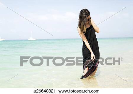 Woman walking on beach View Large Photo Image Stock Image - Woman walking on beach. Fotosearch