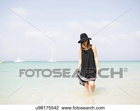 Woman walking on beach View Large Photo Image Stock Image - Woman walking on beach. Fotosearch