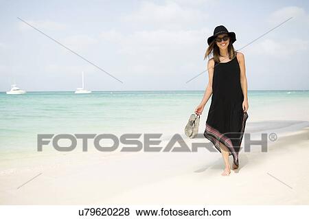 Woman walking on beach View Large Photo Image Stock Photo - Woman walking on beach. Fotosearch