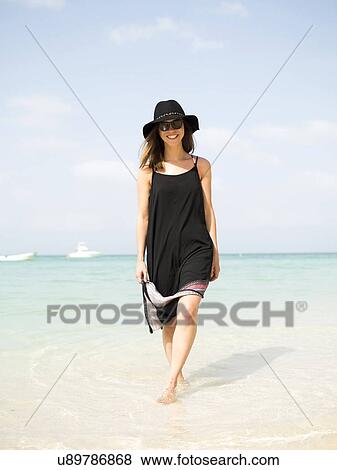 Woman walking on beach View Large Photo Image Stock Photo - Woman walking on beach. Fotosearch