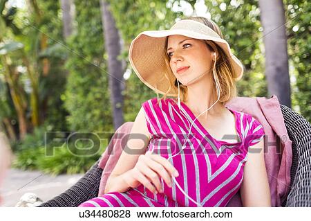 Stock Photo - Woman wearing earphones. Fotosearch
