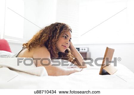 Woman with digital tablet in bed View Large Photo Image Picture - Woman with digital tablet in bed. Fotosearch