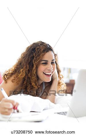 Woman with laptop in bed View Large Photo Image Stock Image - Woman with laptop in bed. Fotosearch