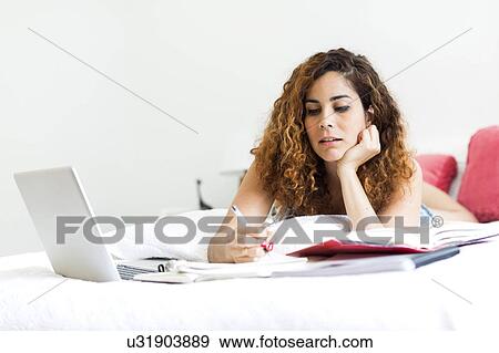 Woman with laptop in bed View Large Photo Image Stock Photo - Woman with laptop in bed. Fotosearch