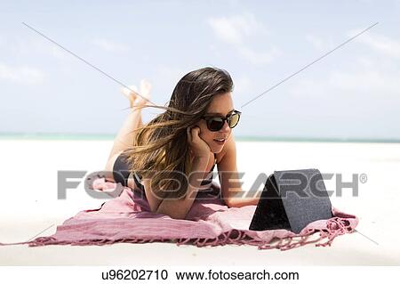 Woman with tablet on tropical beach View Large Photo Image Stock Image - Woman with tablet on tropical beach. Fotosearch
