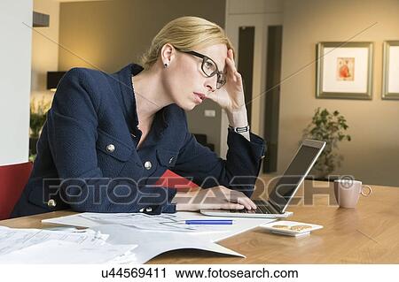 Woman working at desk View Large Photo Image Stock Image - Woman working at desk . Fotosearch