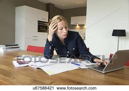 Stock Image - Woman working at desk . Fotosearch