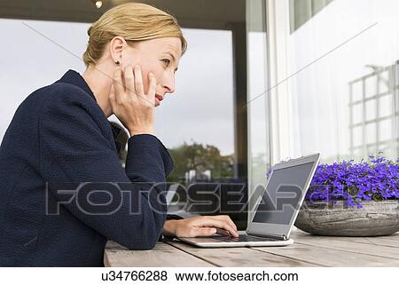 Woman working at desk View Large Photo Image Stock Photo - Woman working at desk . Fotosearch