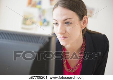 Woman working in office View Large Photo Image Stock Image - Woman working in office. Fotosearch