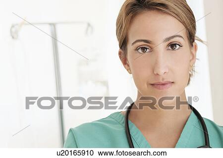 Young female doctor in hospital corridor View Large Photo Image Stock Image - Young female doctor in hospital corridor. Fotosearch