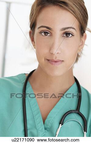 Young female doctor in hospital corridor View Large Photo Image Stock Image - Young female doctor in hospital corridor. Fotosearch
