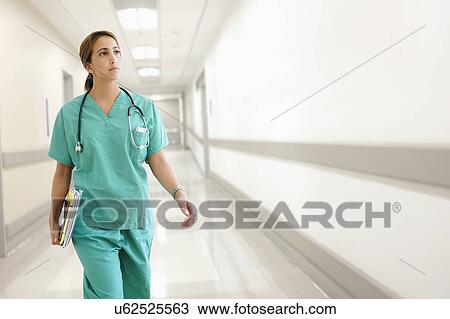 Young female doctor in hospital corridor View Large Photo Image Stock Image - Young female doctor in hospital corridor. Fotosearch