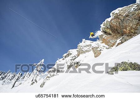 Young man jumping from ski slope View Large Photo Image Stock Image - Young man jumping from ski slope. Fotosearch