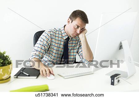 Young man working in office View Large Photo Image Stock Image - Young man working in office. Fotosearch