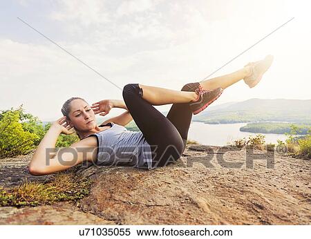 Stock Photography - Young woman exercising outdoor. Fotosearch