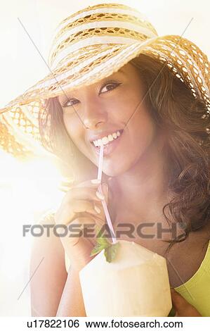 Young woman having drink in sunlight View Large Photo Image Stock Photograph - Young woman having drink in sunlight. Fotosearch