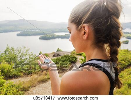 Young woman holding compass View Large Photo Image Stock Photo - Young woman holding compass. Fotosearch