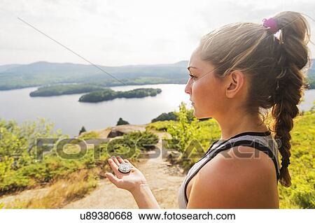 Young woman holding compass View Large Photo Image Stock Photo - Young woman holding compass. Fotosearch