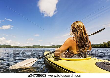 Young woman kayaking on lake View Large Photo Image Stock Image - Young woman kayaking on lake. Fotosearch