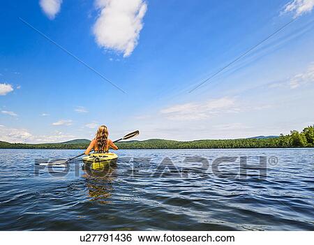 Young woman kayaking on lake View Large Photo Image Stock Photograph - Young woman kayaking on lake. Fotosearch