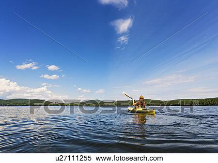Young woman kayaking on lake View Large Photo Image Stock Photography - Young woman kayaking on lake. Fotosearch