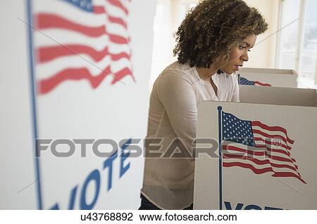 Young woman preparing voting booth View Large Photo Image Stock Image - Young woman preparing voting booth. Fotosearch