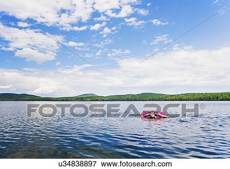 Young woman relaxing on lake in pool raft View Large Photo Image Stock Photo - Young woman relaxing on lake in pool raft. Fotosearch