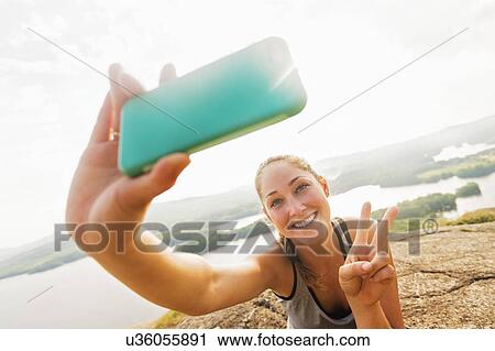 Young woman taking selfie on Smartphone View Large Photo Image Stock Image - Young woman taking selfie on Smartphone. Fotosearch