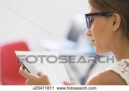 Young woman using mobile phone View Large Photo Image Stock Image - Young woman using mobile phone. Fotosearch