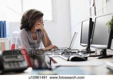 Young woman working at office View Large Photo Image Stock Image - Young woman working at office. Fotosearch