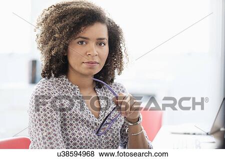 Young woman working at office View Large Photo Image Stock Photo - Young woman working at office. Fotosearch
