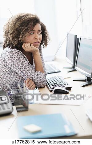 Young woman working at office View Large Photo Image Stock Photography - Young woman working at office. Fotosearch