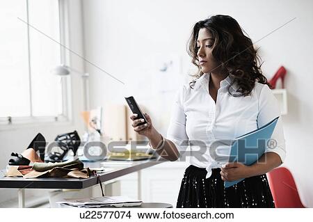 Young woman working in office View Large Photo Image Picture - Young woman working in office. Fotosearch