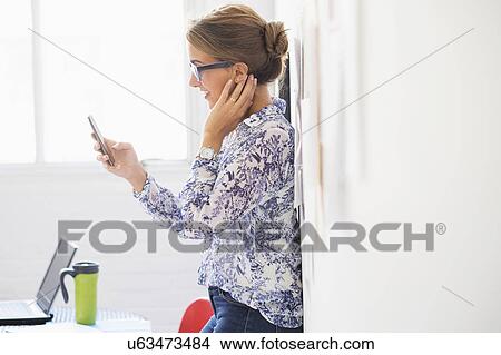 Young woman working in office View Large Photo Image Picture - Young woman working in office. Fotosearch