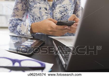 Young woman working in office View Large Photo Image Picture - Young woman working in office. Fotosearch