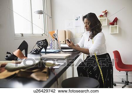 Young woman working in office View Large Photo Image Stock Image - Young woman working in office. Fotosearch