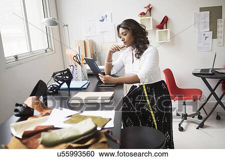 Young woman working in office View Large Photo Image Stock Image - Young woman working in office. Fotosearch