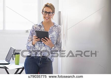 Young woman working in office View Large Photo Image Stock Photography - Young woman working in office. Fotosearch