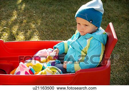 Stock Image -  albq balloon fiesta baby girl child kid red blue. Fotosearch